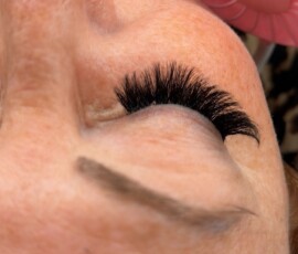 Professional eyelash extensions can provide beautiful results without compromising on quality. Professional lash technician applying eyelash extensions to a client in a beauty salon